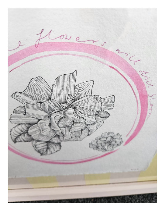 Close up image of a rose illustration in a pink circle and some handwriting