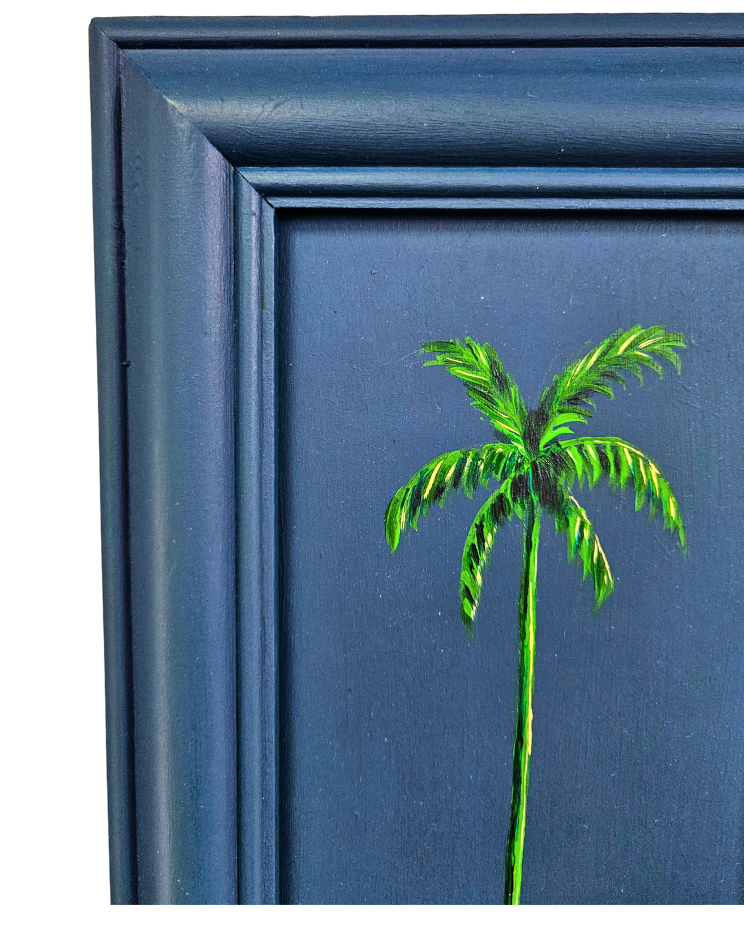 Close up of a painting of a palm tree on a dark blue background