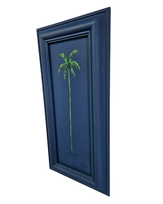 angled view of a framed artwork of a palm tree on a blue background