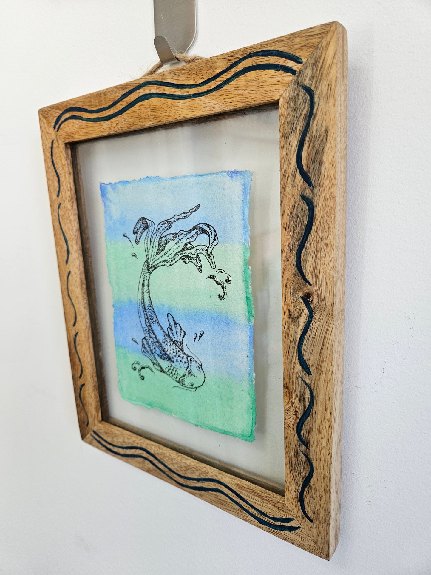 koi illustration in a frame on a wall
