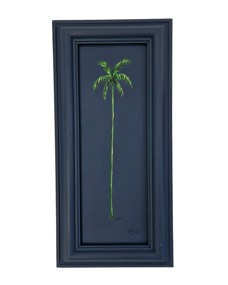 Framed artwork of a green palm tree on a dark blue background