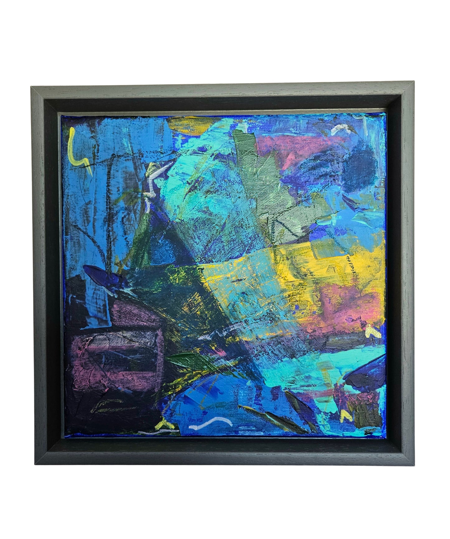 Abstract painting with vibrant colors in a dark grey frame on a white background