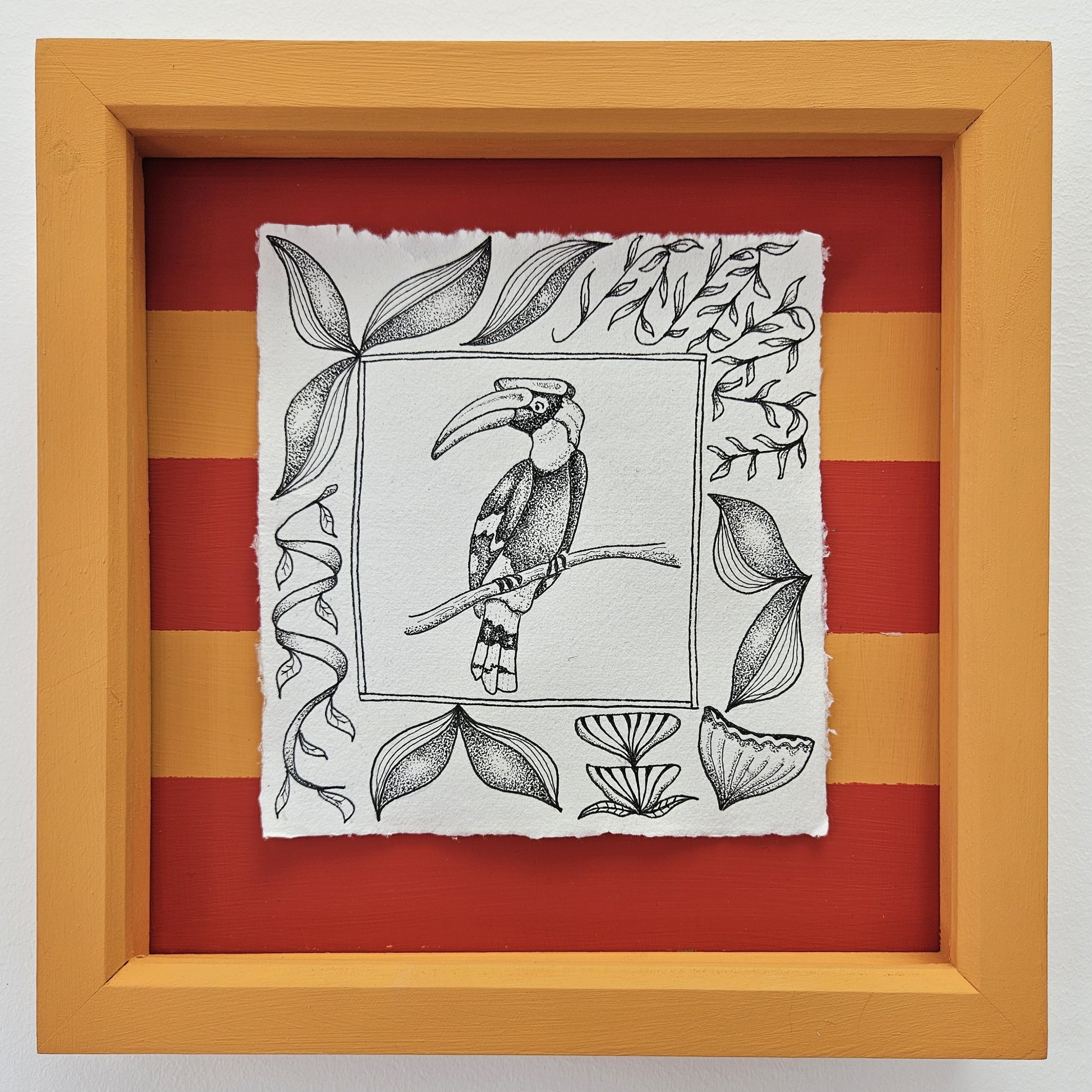 Pen and ink illustration of a hornbill with a border of leaves. An orange and red striped background and an orange painted box frame