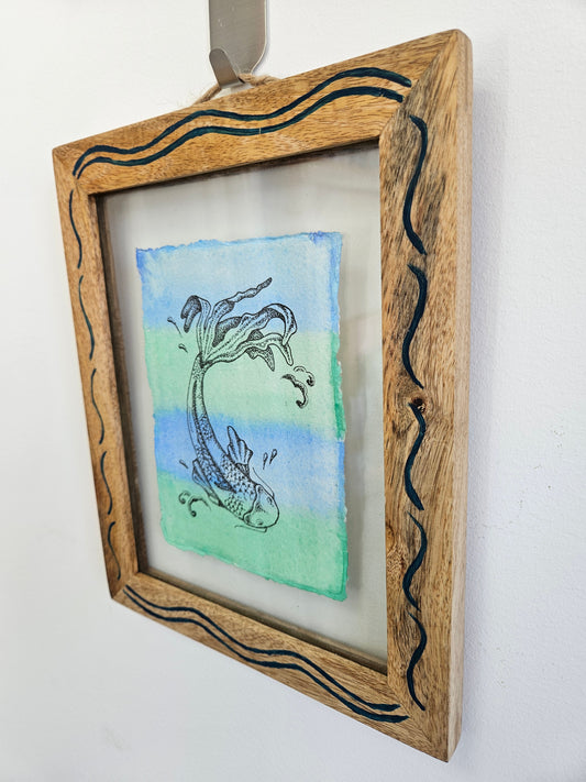 koi illustration in a frame on a wall