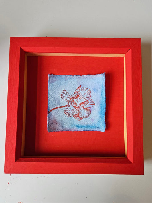 Drawing of a magnolia in a red frame
