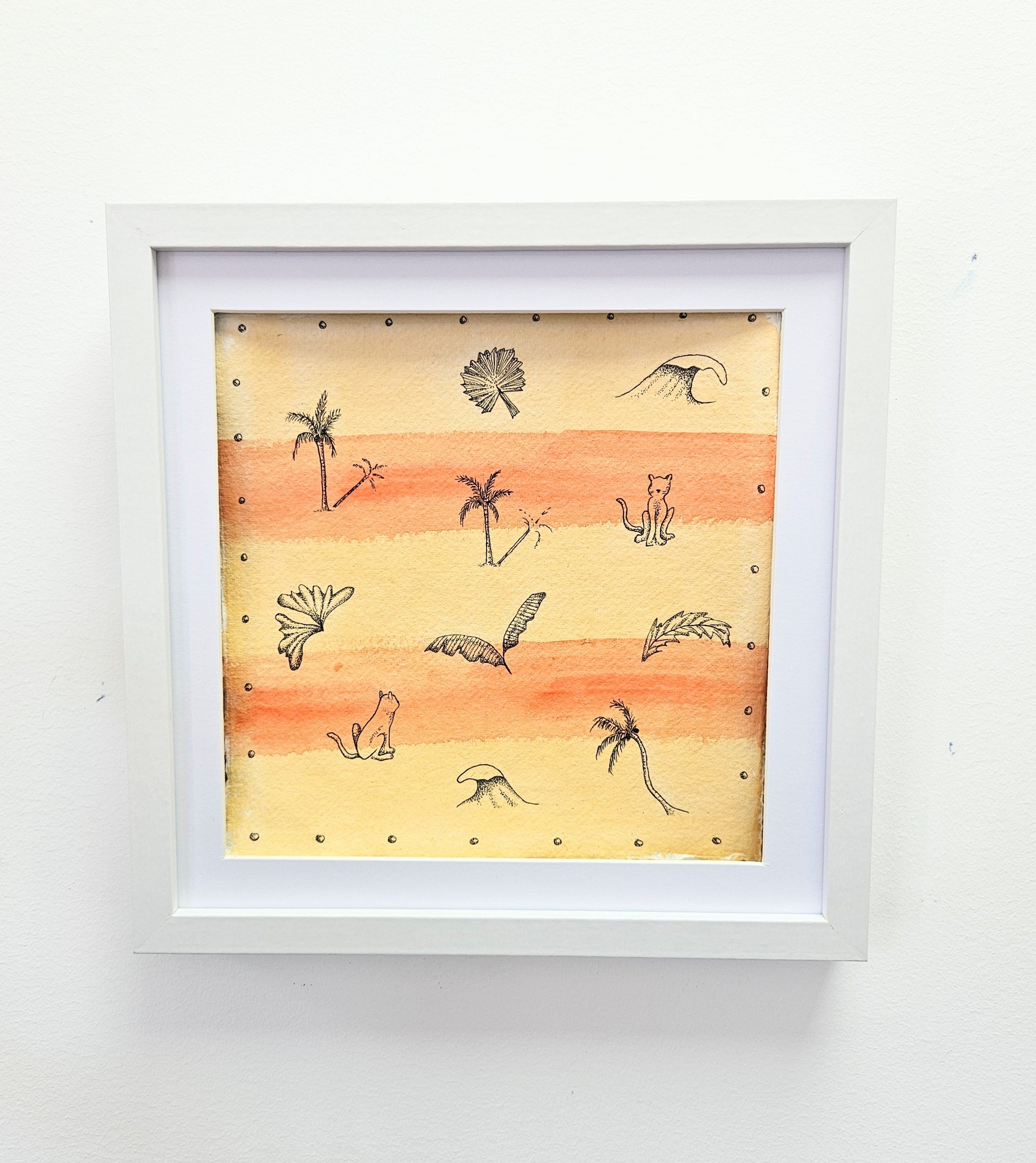 Framed illustrated artwork with a sunset background, featuring palm trees, waves, and cats.